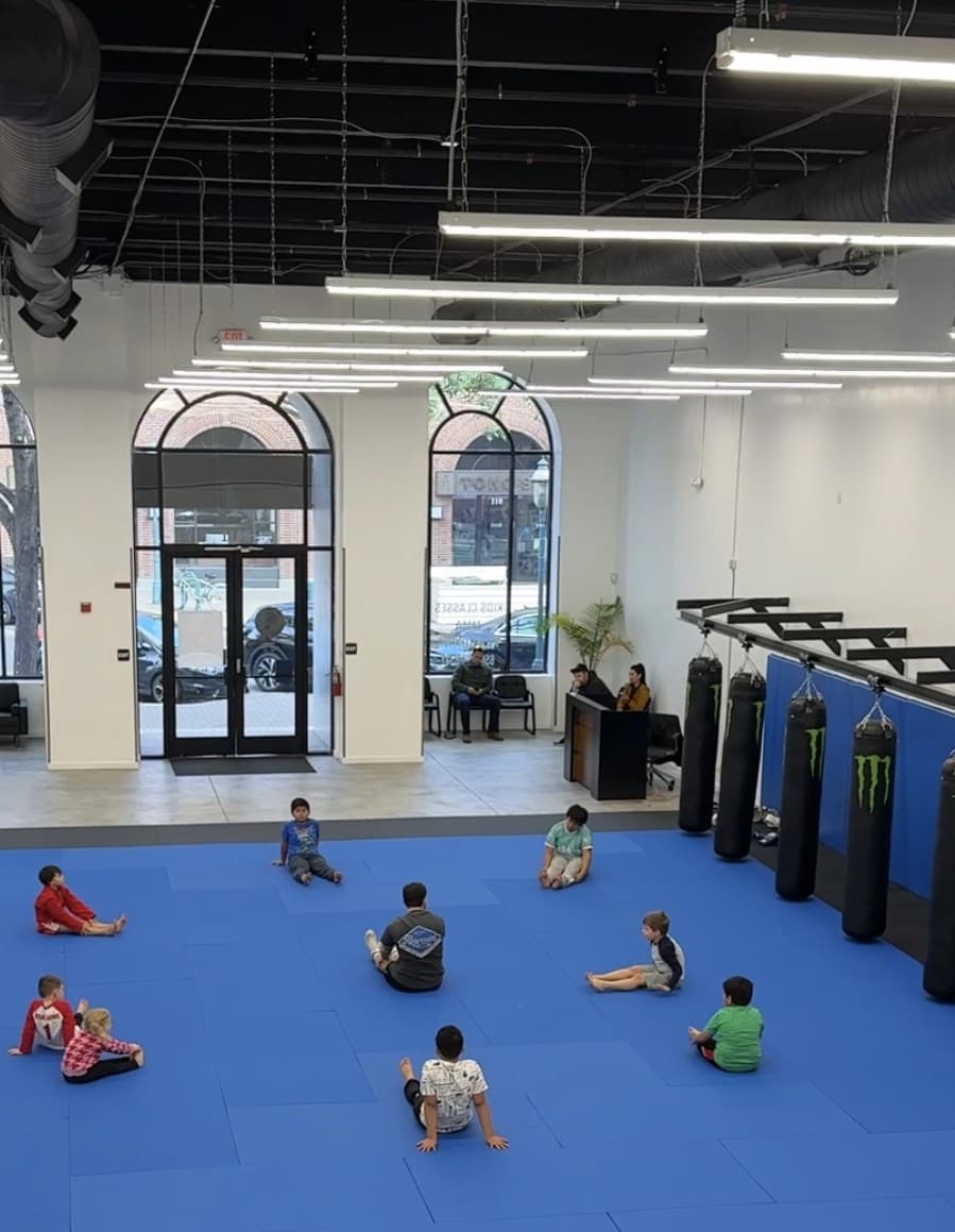 Kids stretching on the mats during class