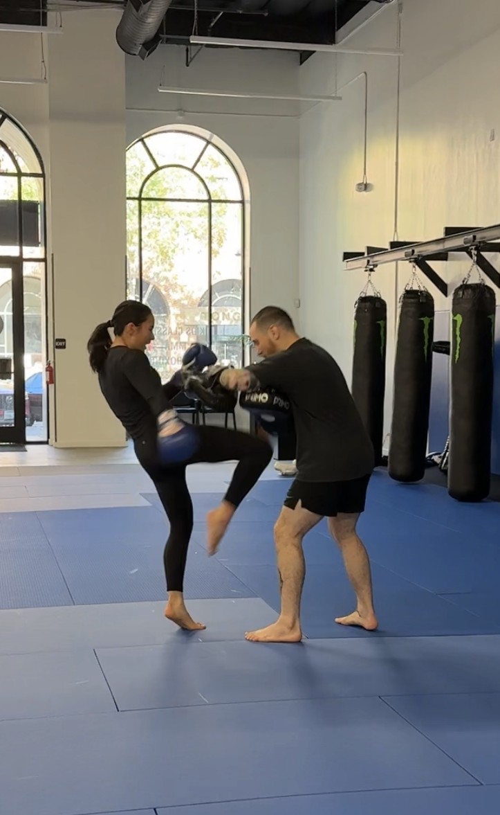 A coach holding kick pads